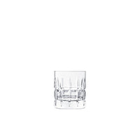 A clear, empty crystal glass from the Saint-Louis Manhattan Barware collection featuring a textured cut pattern is centered on a plain white background.