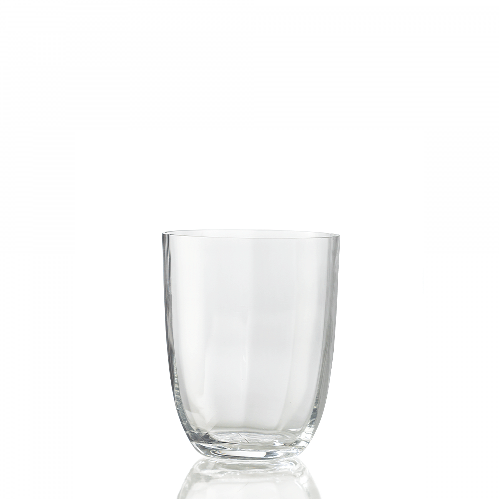 The Idra Tumbler Optic by Nason Moretti is a clear glass with smooth, optic-textured sides, centered on a white background and reflecting subtly at its base.