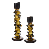 The Fortress Candleholder by Accent Decor features two amber glass holders with irregular, stacked shapes and glossy finish. One is taller than the other, both with round bases—unique statement pieces for your decor.