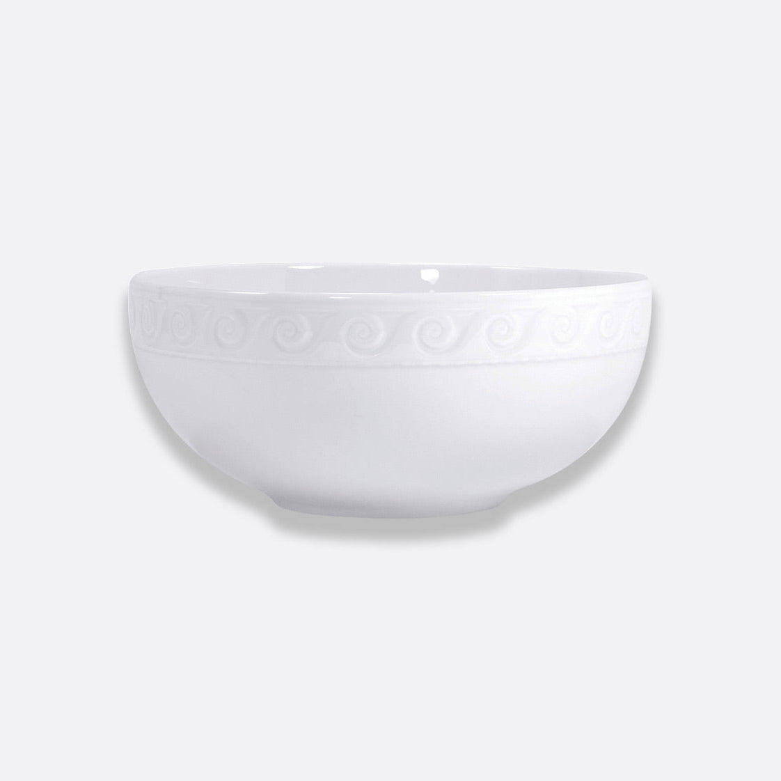 The Bernardaud Louvre Dinnerware features a plain white ceramic bowl with an embossed swirl rim, inspired by Renaissance French architecture, displayed on a light gray background.