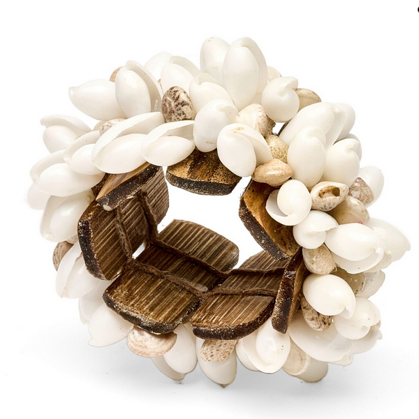 The Shell Cuff Napkin Ring Set of 4 by Deborah Rhodes features clustered white and beige seashells with brown wooden accents on an elastic band, beautifully handcrafted and displayed on a white background.
