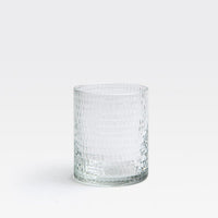 The Duncan Glassware Clear tumbler by Blue Pheasant, featuring a textured dimpled surface, sits empty on a white background—combining timeless bar style with everyday versatility.
