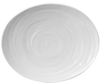 A plain, round, white Bernardaud Origine Dinnerware plate with a subtle spiral pattern, photographed from above on a white background.
