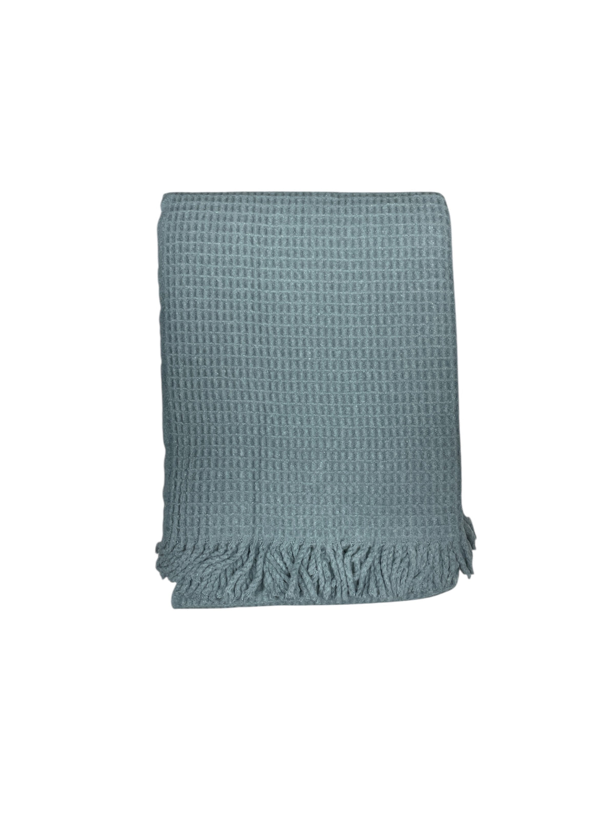The Basic Waffle Throw by A Soft Idea is a light blue cotton acrylic blanket with a textured waffle weave and fringed edges. Machine washable for easy care, it combines style and comfort, shown folded against a white background.