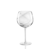 The Nason Moretti Tolomeo Red Wine Glass, expertly blown with a clear wide bowl and long stem, stands upright against a plain white background.