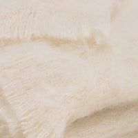 Close-up of the Brushed Cream Alpaca Throw by Lands Downunder, showing its soft, fluffy texture and visible fibers—crafted in New Zealand for warmth and comfort.