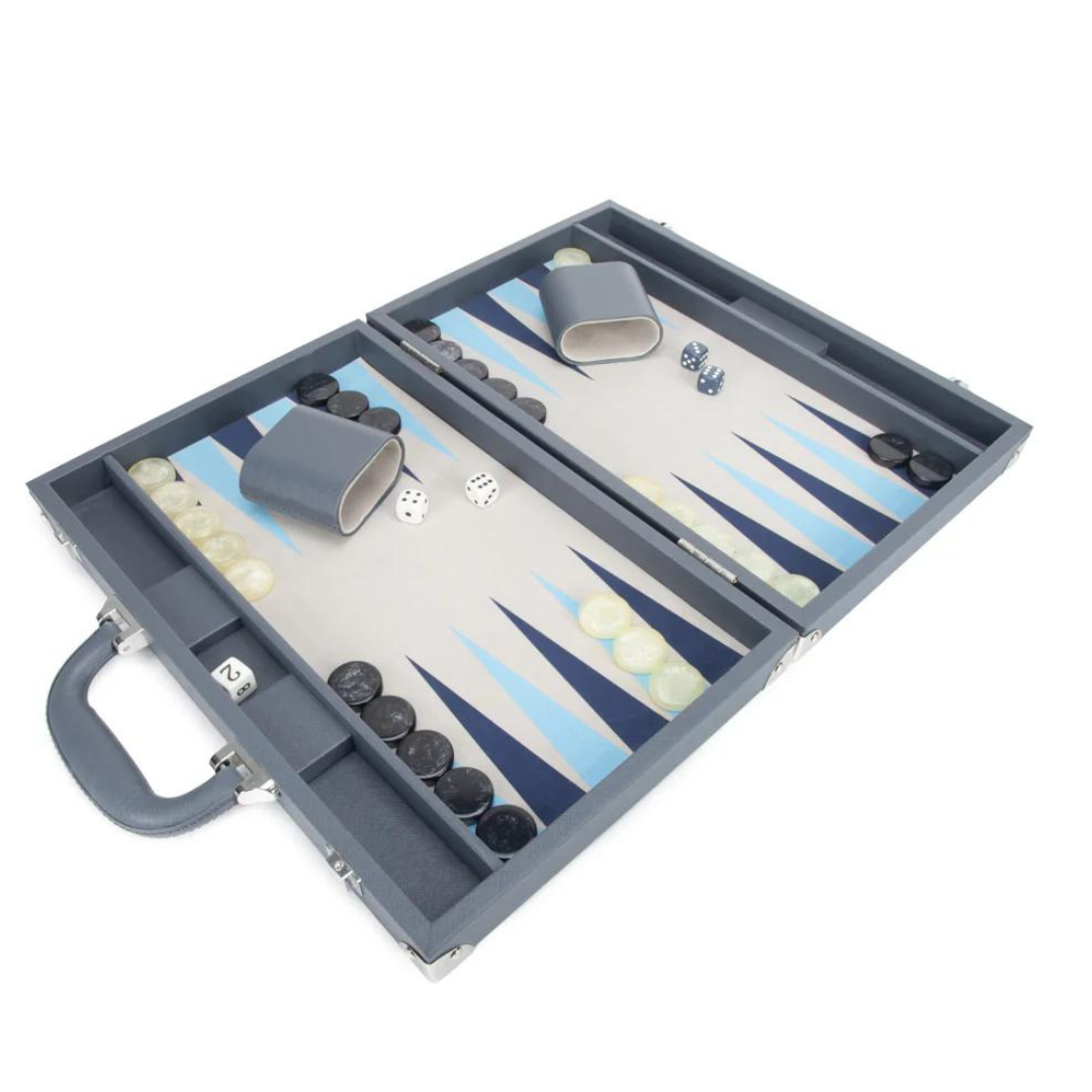 The Brouk & Co Excelsior Backgammon Set features an open blue vegan leather case with handle and clasps, two dice cups, white and black checkers, dice, and a board with blue and white triangles—perfect for game night.