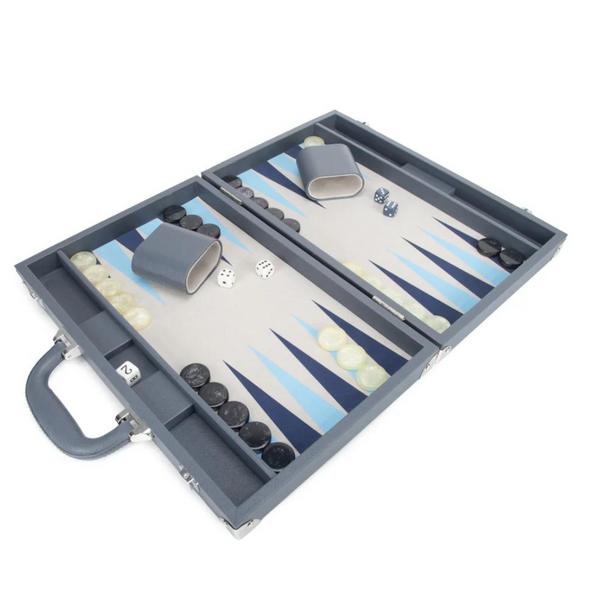 The Brouk & Co Excelsior Backgammon Set features an open blue vegan leather case with handle and clasps, two dice cups, white and black checkers, dice, and a board with blue and white triangles—perfect for game night.