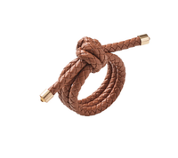 The Kim Seybert Rope Knot Napkin Ring Set of 4, made from braided brown faux leather with metallic gold caps in a loose knot design, adds subtle coastal flair to your table, shown here against a white background.
