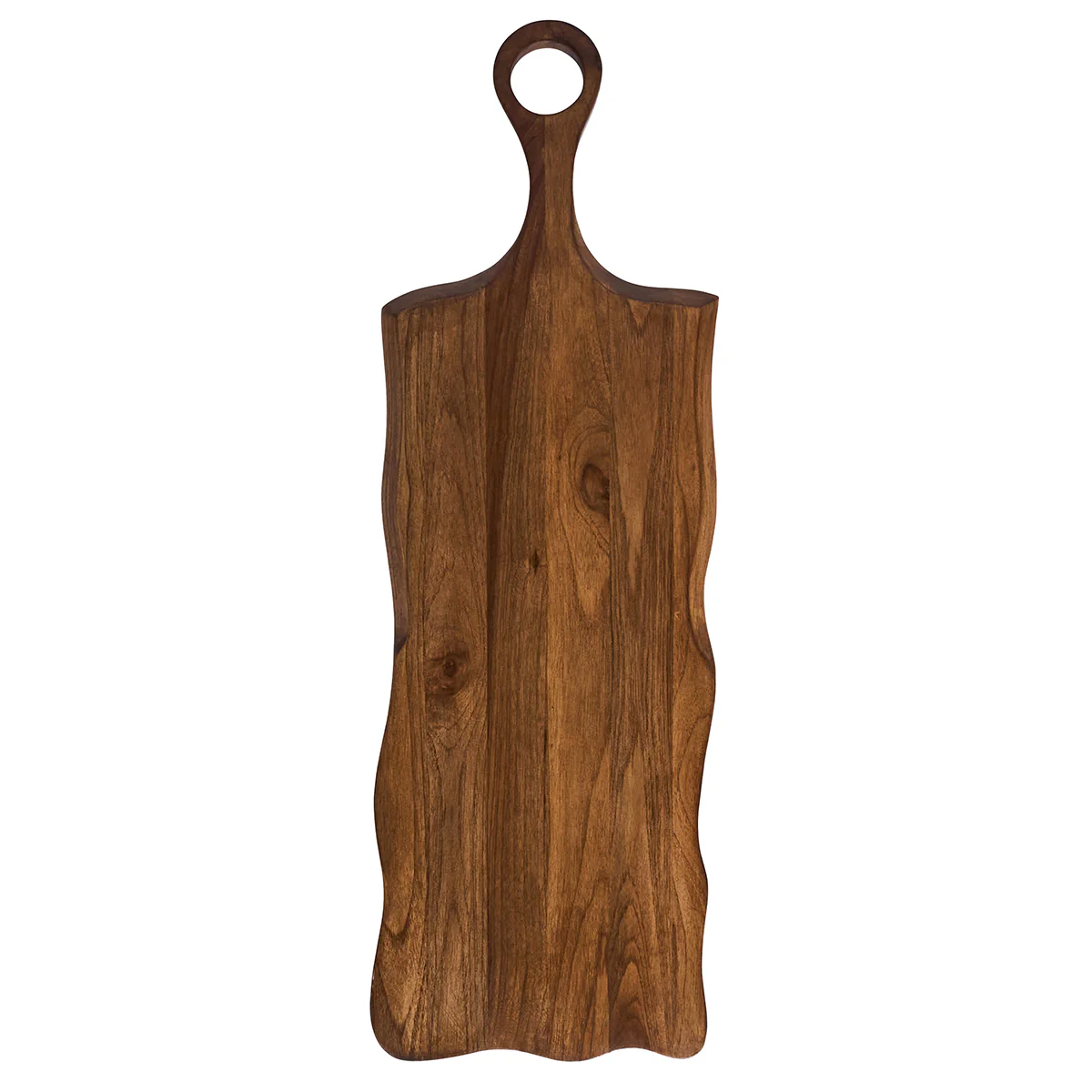The Juliska Puro Long Serving Board Teak is a long, rectangular serving board with wavy edges and a rounded handle featuring a circular hole for hanging. Crafted from solid teak wood, this rustic artisanal piece is perfect as both a prep surface and one of your most distinctive serving boards.