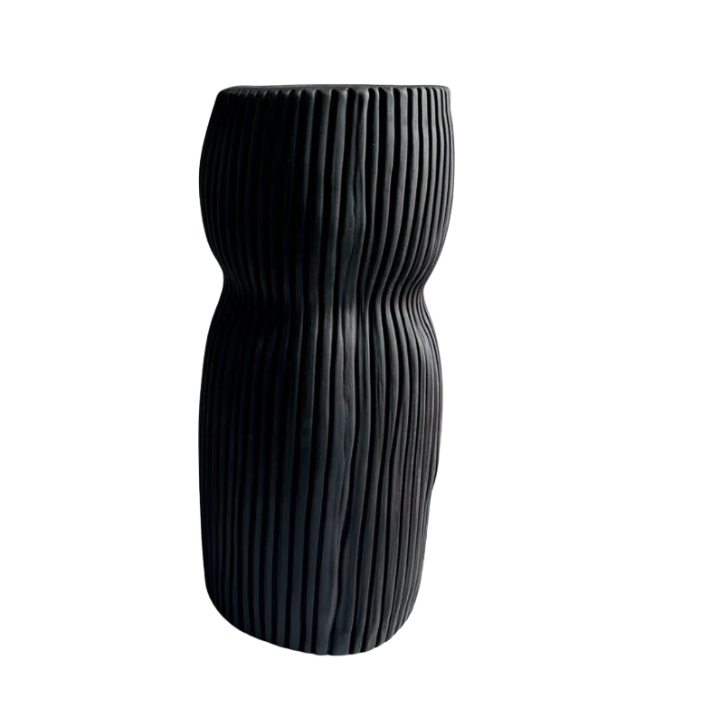 The Curvy Round Vase Black by CYM Warkov Ceramics features a tall, wavy silhouette with vertical ridges and a striking black finish, creating an eye-catching sculptural piece against any white background.