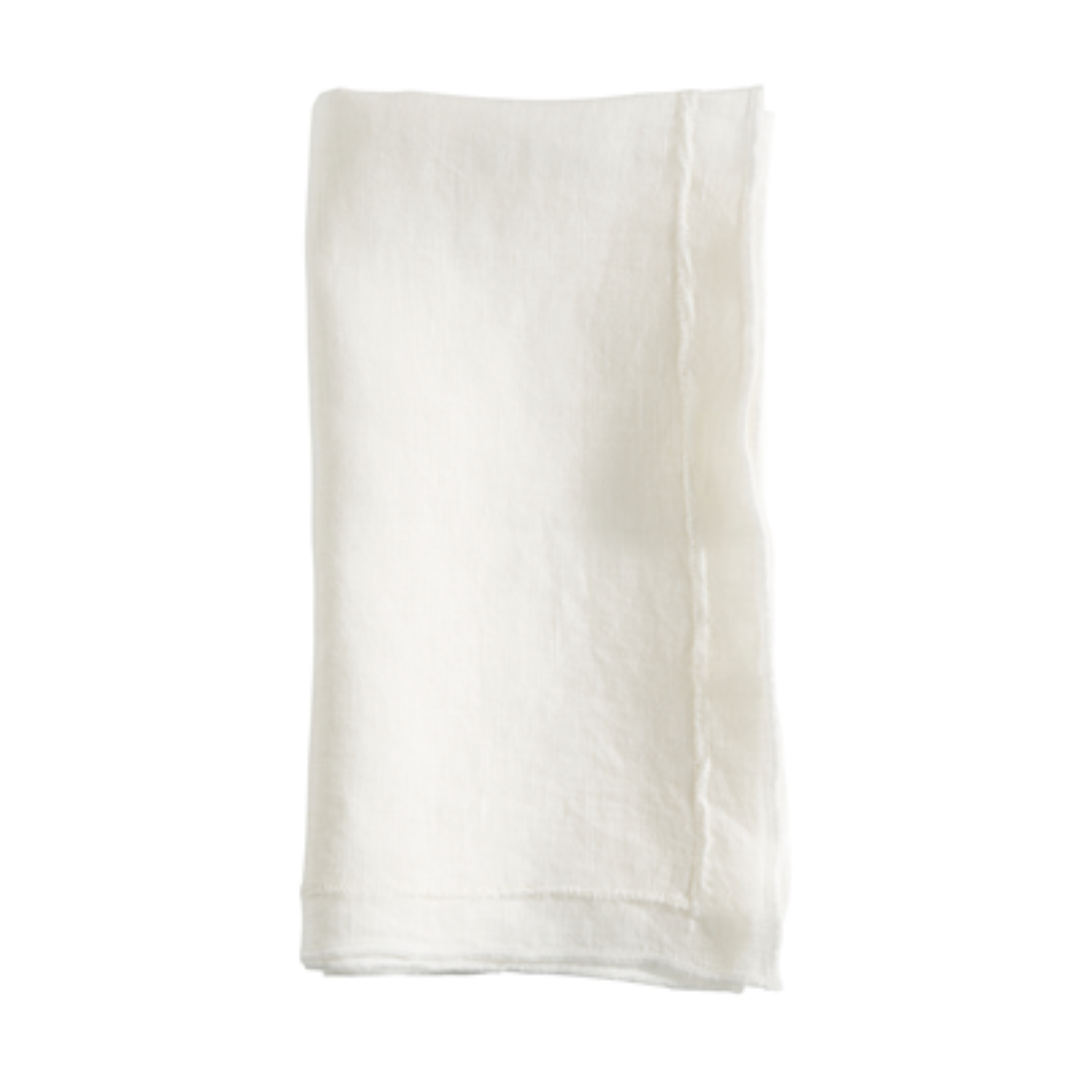 The Saro Trading Overlock Stonewash Border Napkin, a plain white cloth napkin with subtly frayed edges for a classic touch, is displayed neatly folded against a white background.