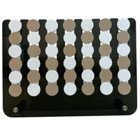 The Connect Four JUMBO EDITION El Cuatro by Luxe Dominoes is a rectangular black oversized board game with five vertical rows of alternating beige and white disks—perfect for adding fun to family game night.