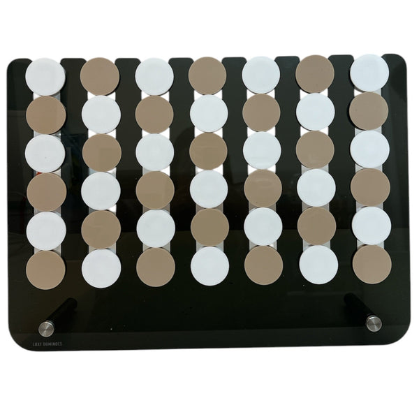 The Connect Four JUMBO EDITION El Cuatro by Luxe Dominoes is a rectangular black oversized board game with five vertical rows of alternating beige and white disks—perfect for adding fun to family game night.