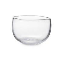 The Burlington Bowl by Simon Pearce is a clear, round handmade glass bowl with slightly uneven edges and an organic design, shown on a plain white background.