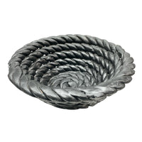 The Tissit Bowl Matte Black by Schwung Design is a sculptural ceramic bowl with a matte finish and rope-inspired spiral texture, creating a striking modern accent piece.