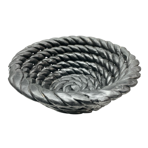 The Tissit Bowl Matte Black by Schwung Design is a sculptural ceramic bowl with a matte finish and rope-inspired spiral texture, creating a striking modern accent piece.