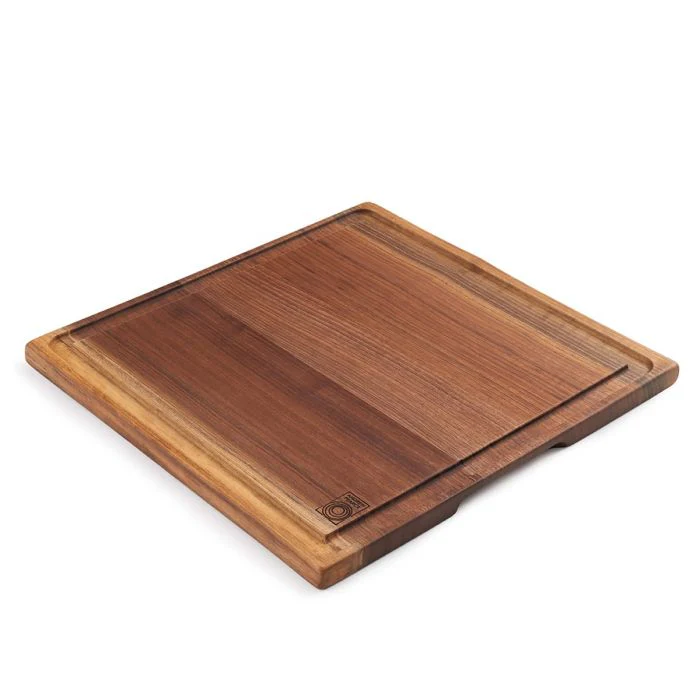 The Andrew Pearce Large Carving Board—Black Walnut is handmade in the USA from sustainably harvested hardwood, featuring a groove, striking grain patterns, and a branded logo in one corner—all shown on a white background.