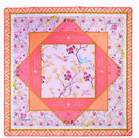 The Mahjong Mats by Oh My Mahjong feature a colorful non-slip surface with floral and bird designs in pink, orange, and gold, geometric borders, game markings, and the OH MY MAHJONG logo in two corners.