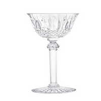 The Saint-Louis Tommy Stemware features a clear, intricately cut crystal coupe glass with a decorative bowl, faceted stem, and flared base—an elegant luxury piece displayed on a white background.