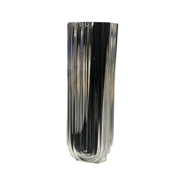 The Heater Vase - Black Splash by Matt Kolbrener features a tall, rectangular form with vertical ridges and a glossy metallic finish, showcasing industrial modern style against a plain white background.
