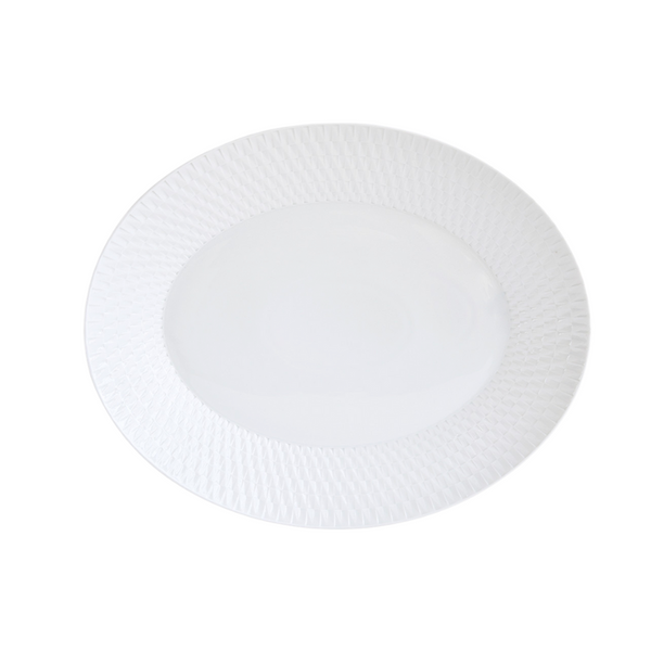 The Bernardaud Twist Oval Platter - 15" is a white ceramic plate with a geometric rim pattern and smooth center, shown on a plain white background.