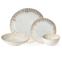 The Casafina Mallorca Dinnerware set includes four white ceramic pieces—two plates and two bowls in different sizes—with scalloped, textured edges and a subtle beige rim for an elegant look.