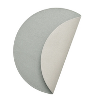 The Kim Seybert Icons Placemat Set of 4 features reversible, semi-circular placemats in light gray with an off-white underside and subtle shagreen texture, shown partially folded against a white background.