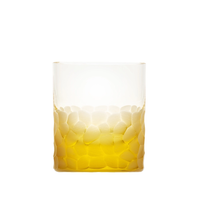 The Pebbles DOF 370 ml by Moser is a hand-blown, lead-free Czech crystal tumbler featuring a textured, frosted pattern and partially filled with a golden yellow liquid.