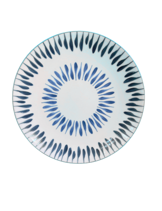 The Marie Daâge Allee de Cypres 5 plate by Marie Daâge is a round white Limoges porcelain piece with blue teardrop motifs in concentric circles, adding elegance to your luxury tableware collection.