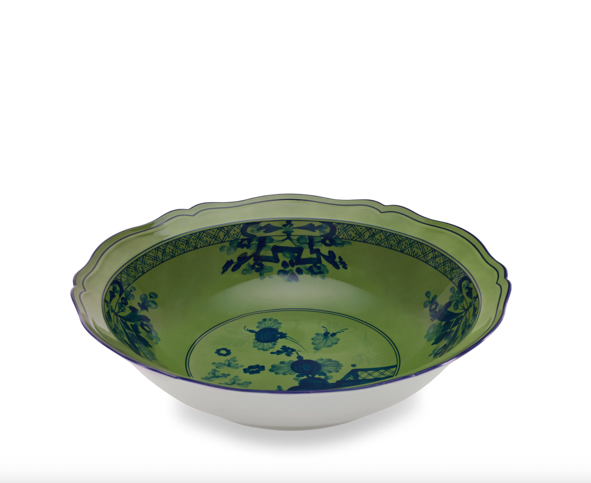 Green porcelain bowl from the Ginori 1735 Oriente Italiano Dinnerware Malachite collection, featuring a scalloped edge and blue floral illustrations.