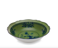 Green porcelain bowl from the Ginori 1735 Oriente Italiano Dinnerware Malachite collection, featuring a scalloped edge and blue floral illustrations.