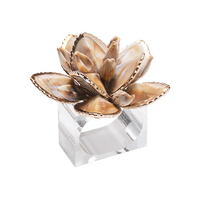 The Kim Seybert Beachcomber Napkin Ring Set of 4 features layered shiny brown seashell flowers and shell beads on a clear base, adding coastal elegance to your table.