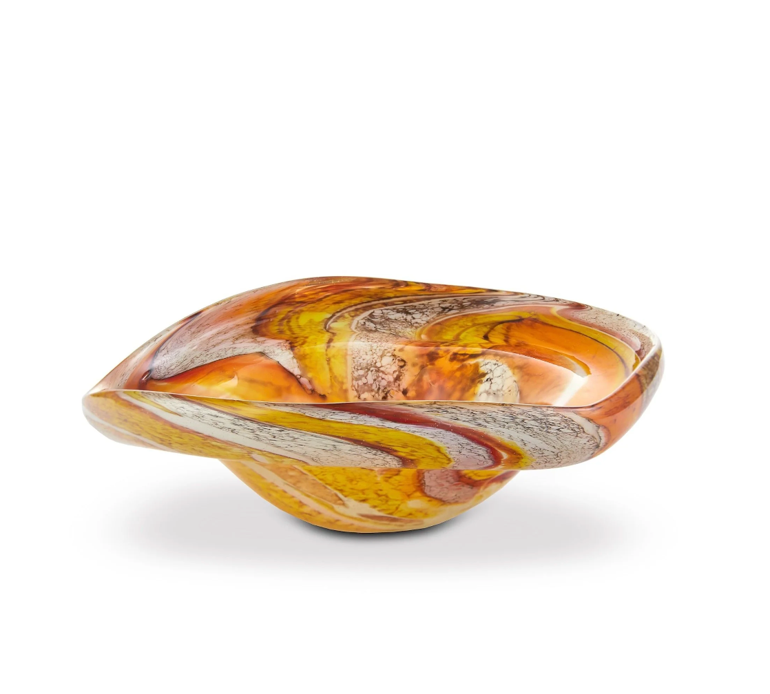 Yakush’s Aura Small Catchall Bowl is a curved, handmade blown glass piece featuring swirling patterns in orange, yellow, and brown tones on a white background—perfect as a vibrant jewelry catchall.