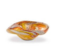 Yakush’s Aura Small Catchall Bowl is a curved, handmade blown glass piece featuring swirling patterns in orange, yellow, and brown tones on a white background—perfect as a vibrant jewelry catchall.