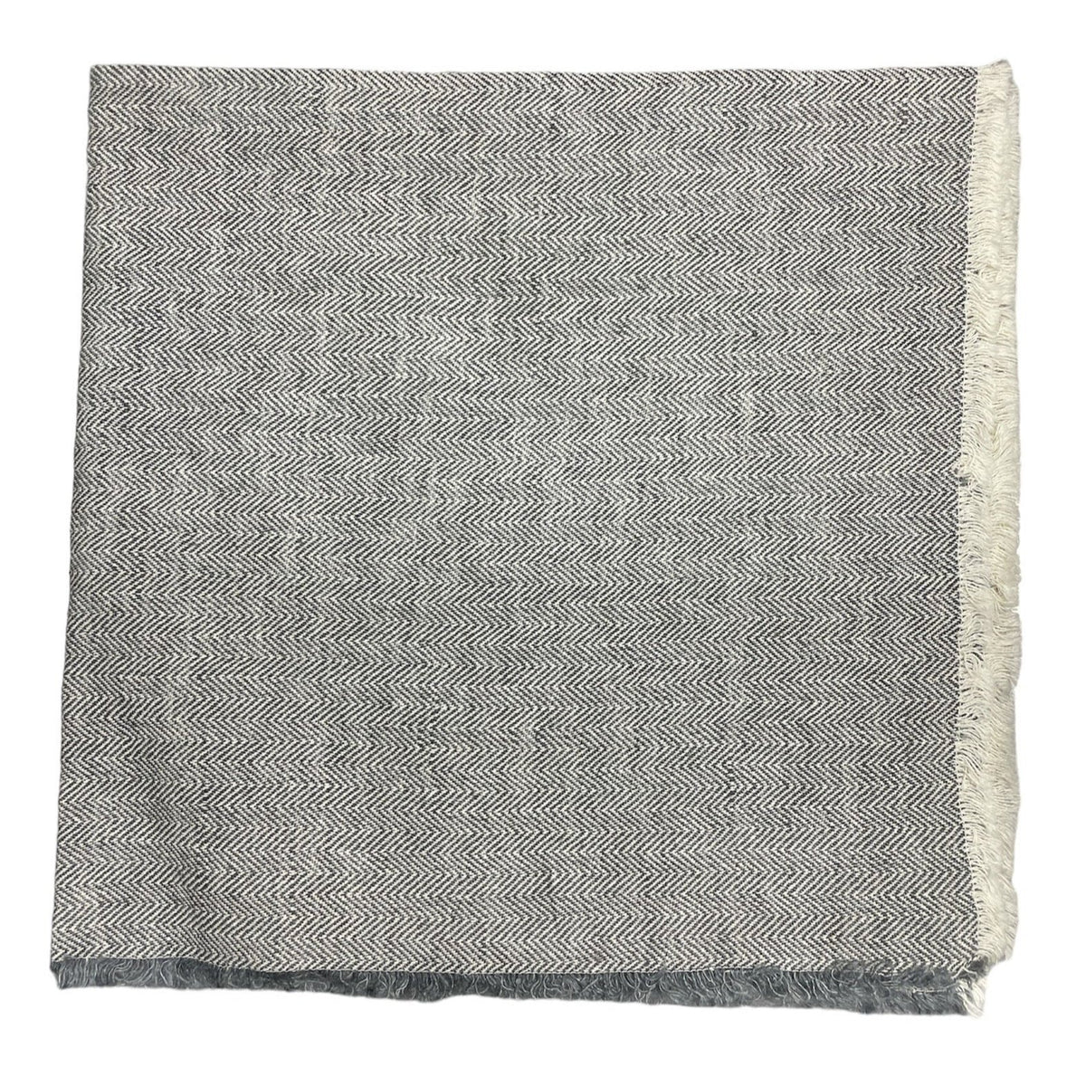 The Deborah Rhodes Herringbone Fringe Napkin Steel Set of 4 features a folded herringbone design with short fringe on the right and bottom edges, shown against a plain white background.