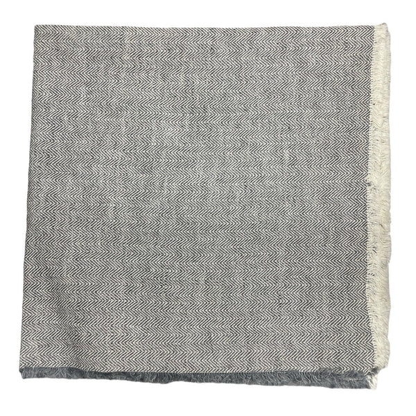 The Deborah Rhodes Herringbone Fringe Napkin Steel Set of 4 features a folded herringbone design with short fringe on the right and bottom edges, shown against a plain white background.