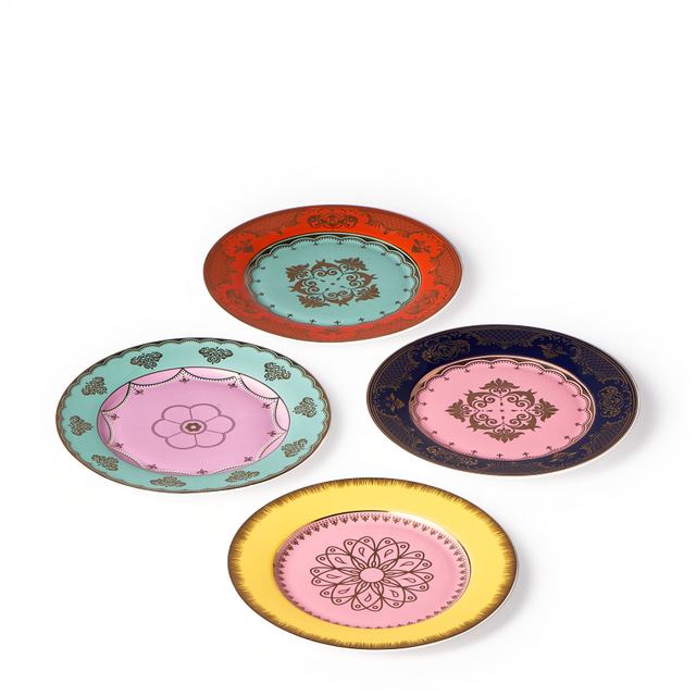 The Polspotten Grandpa Canape Plates Multi Set of 4 features porcelain side plates with ornate gold designs on white, each in a unique color—red, green, dark blue, and yellow—and arranged in a diamond shape.
