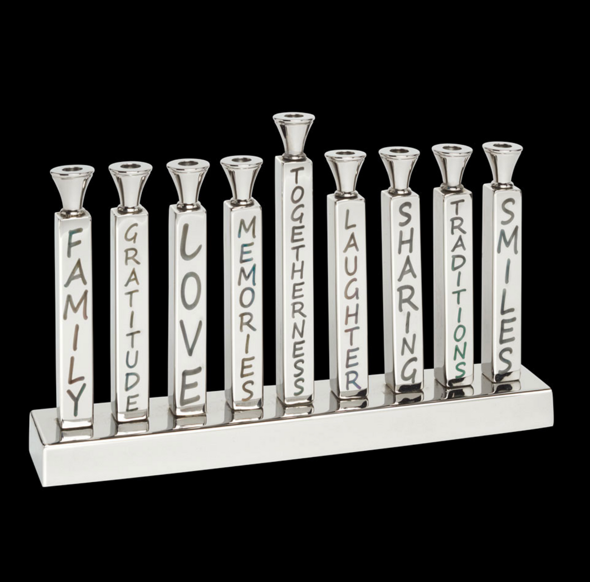 Illuminate your Hanukkah with the Mimi Menorah from Inspired Generations. This eye-catching silver aluminum candle holder features candles labeled Family, Gratitude, Love, Memories, Togetherness, Laughter, Sharing, Traditions, and Smiles. Set against a dramatic black background, the Mimi Menorah makes a meaningful gift and elegant centerpiece for your holiday celebrations.