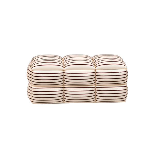 The Jasper Stripe Box by A Sanoma Inc is a rectangular, cream-colored ottoman adorned with evenly spaced horizontal brown stripes, resembling stacked cushioned squares—a perfect accent to enhance contemporary elegance against a white background.