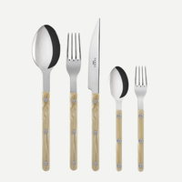 The Sabre Bistrot Solid Flatware 5 Piece Setting - Shiny features Paris-inspired beige-handled utensils with metal rivets. Includes a large spoon, fork, knife, small spoon, and small fork displayed on a white background.