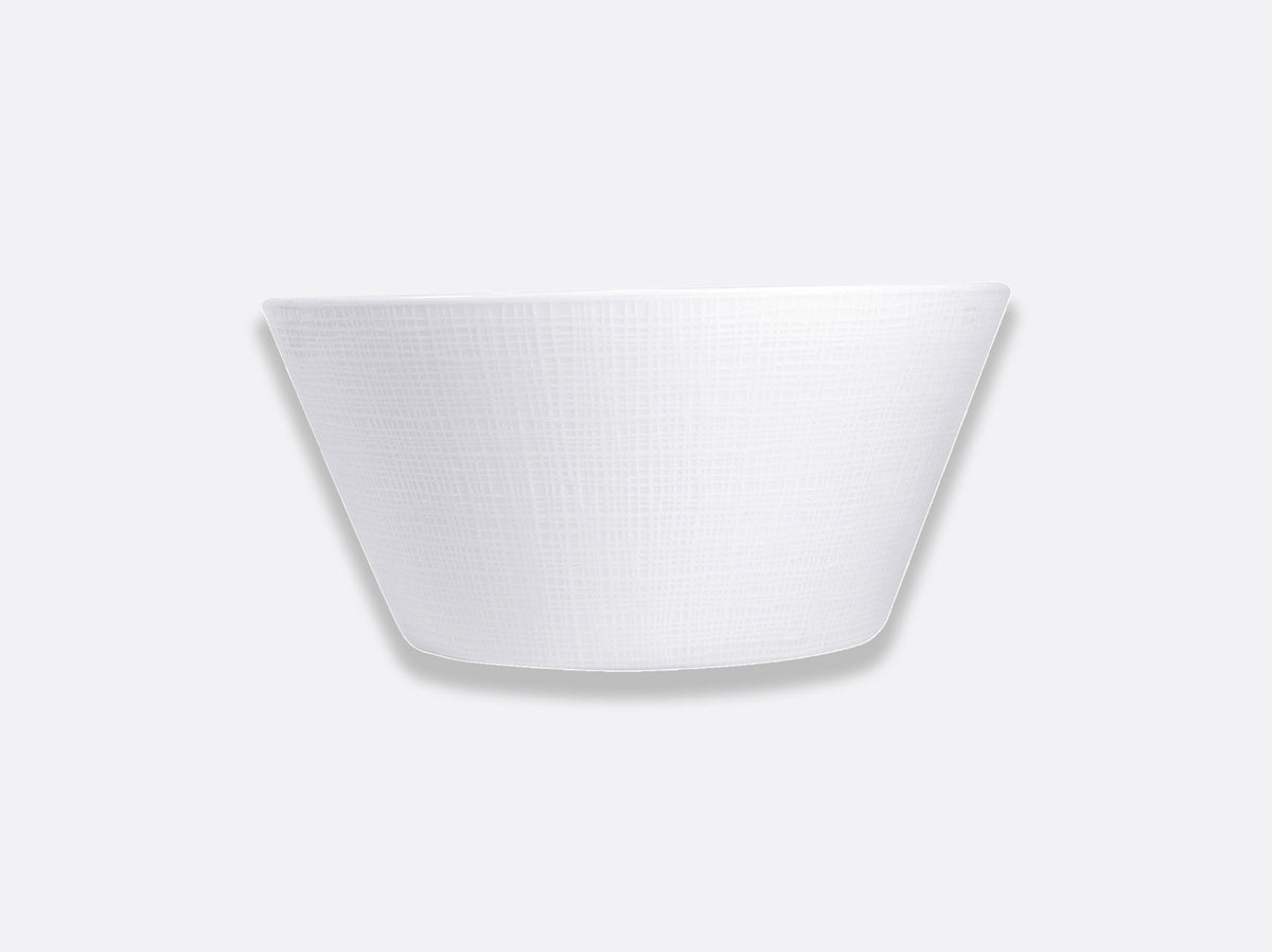 The Bernardaud Organza White Dinnerware features a textured, white Limoges porcelain bowl with sloping sides, centered on a light gray background—an elegant choice for minimalist interior décor.