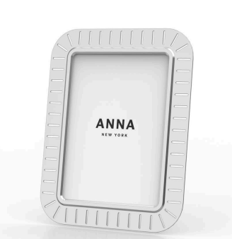 The Anna New York Striations Frame Silver features vertical etched lines on its border, stands upright, and displays "ANNA NEW YORK" against a plain white background for a modern look.