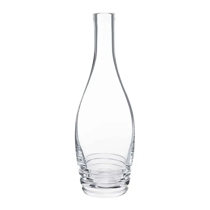The Oxymore Carafe by Saint-Louis/Hermes is a clear glass piece with a narrow neck, wide rounded base, and three stacked rings at the bottom, shown empty against a white background.