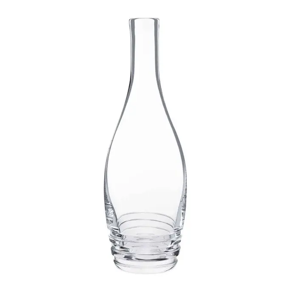 The Oxymore Carafe by Saint-Louis/Hermes is a clear glass piece with a narrow neck, wide rounded base, and three stacked rings at the bottom, shown empty against a white background.