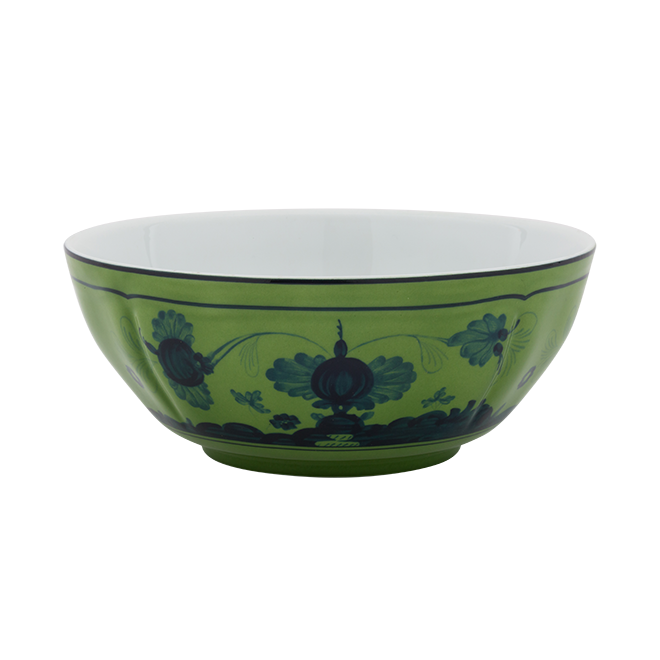 The Ginori 1735 Oriente Italiano Dinnerware Malachite bowl features a glossy green exterior with intricate dark blue floral and ornamental patterns in classic Italian style, while its interior is plain white.