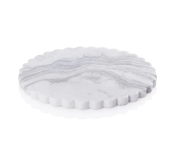 The Zodax Dolly Marble Cheese Board features a round, white marble surface with subtle gray veining and elegant scalloped edges, showcased on a clean white background.