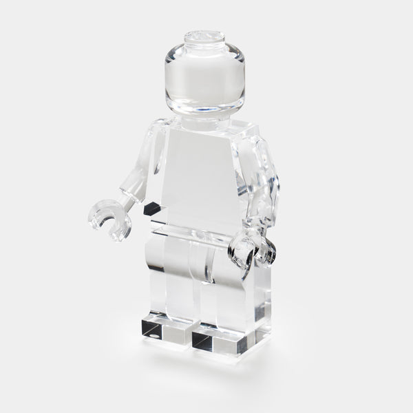 The Luho Brix Sculpture features a clear Lego-style minifigure on a white background, offering a whimsical home accent and unique clear acrylic decor piece.