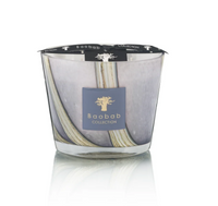 The Baobab Woods Broceliande Candle features a marbled gray and white glass, a black lid, and a gold tree logo inspired by Brittany's Brocéliande forest.