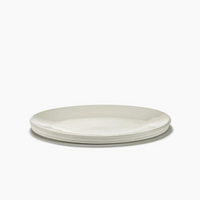 The Serax Dune Oval Platter Alabaster - 18" features a sleek, minimalist design. Three of these elegant white ceramic platters are stacked neatly against a plain white background.